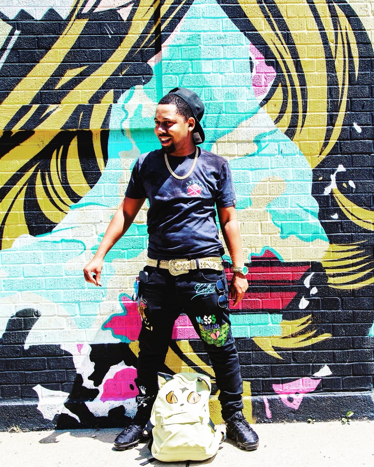 Mike Moore in front of a colorful Chicago mural