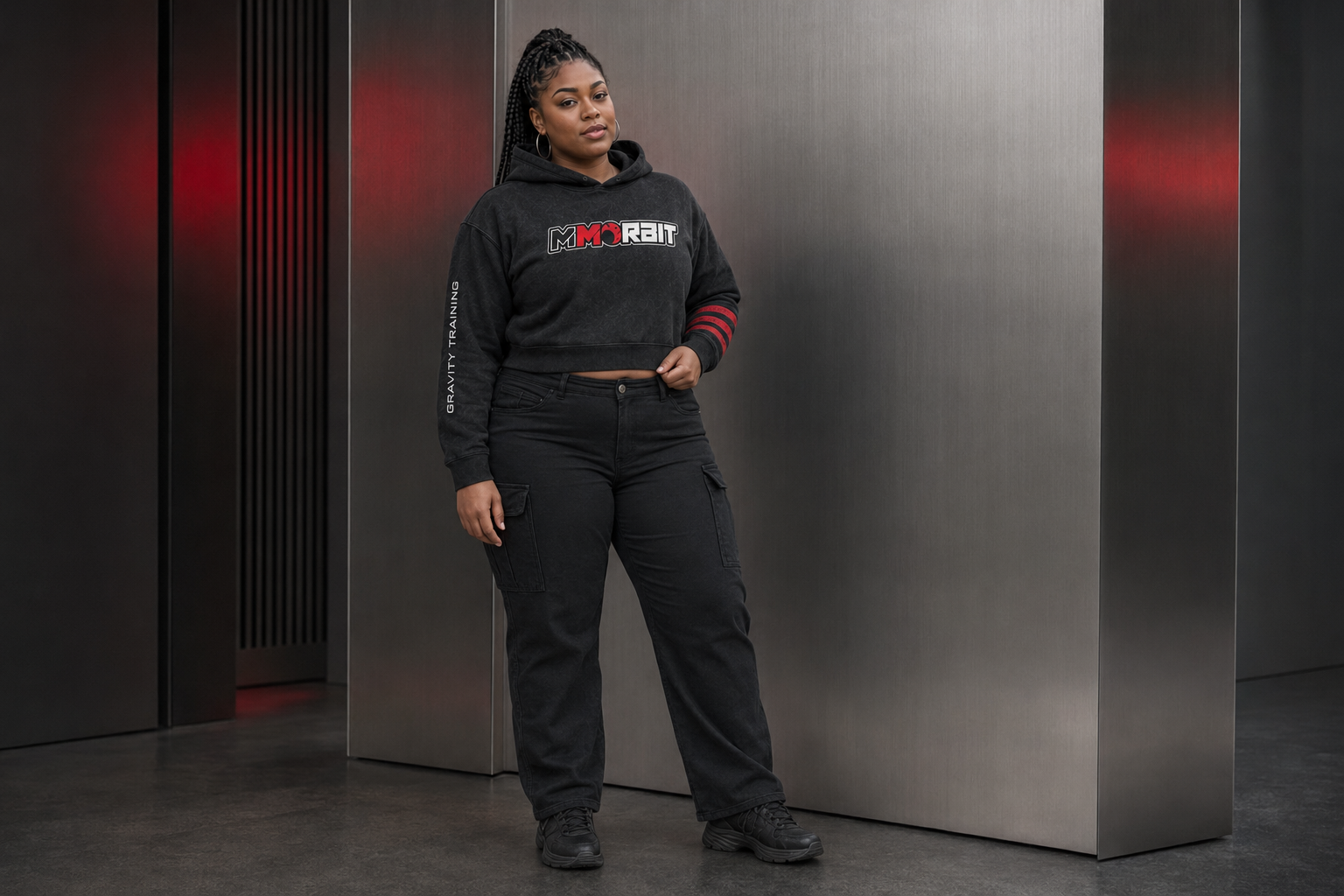 One adult woman showing the cropped waist and contoured body of the feminine MMORBIT Gravity Training hoodie
