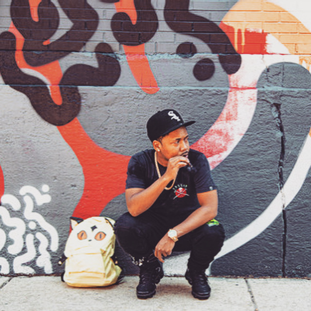 Mike Moore photographed against Chicago street art