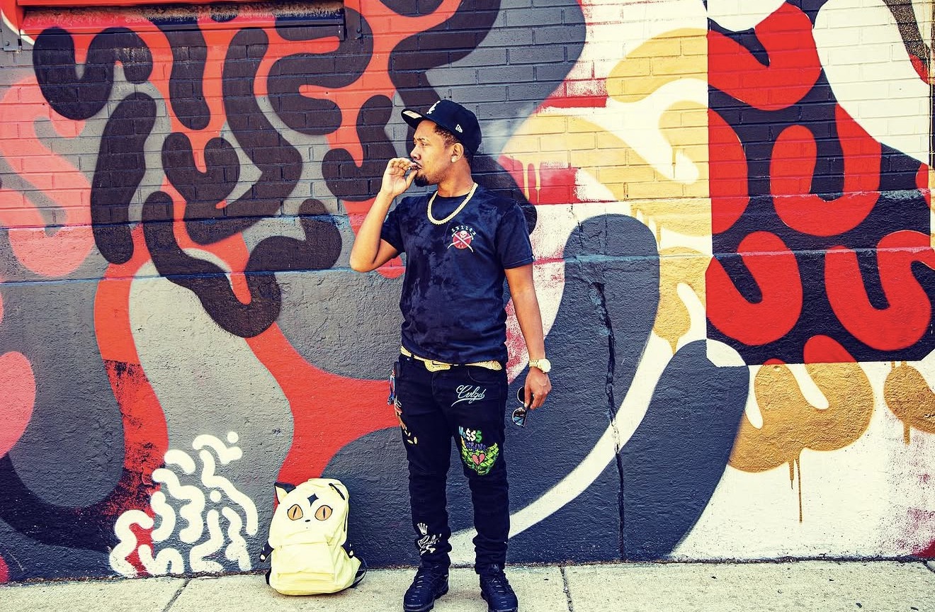 Mike Moore standing in front of a colorful Chicago mural